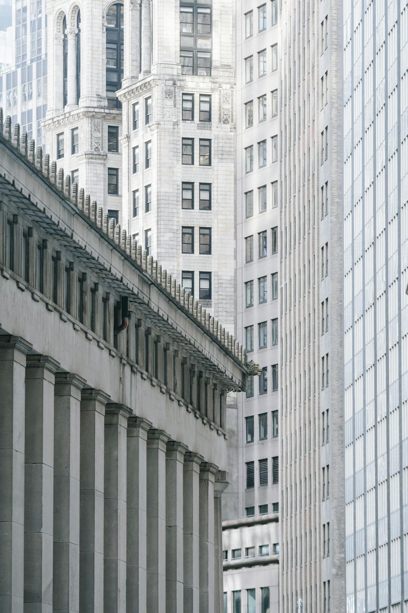 A blend of classical and modern architecture in an urban setting showcasing tall buildings.