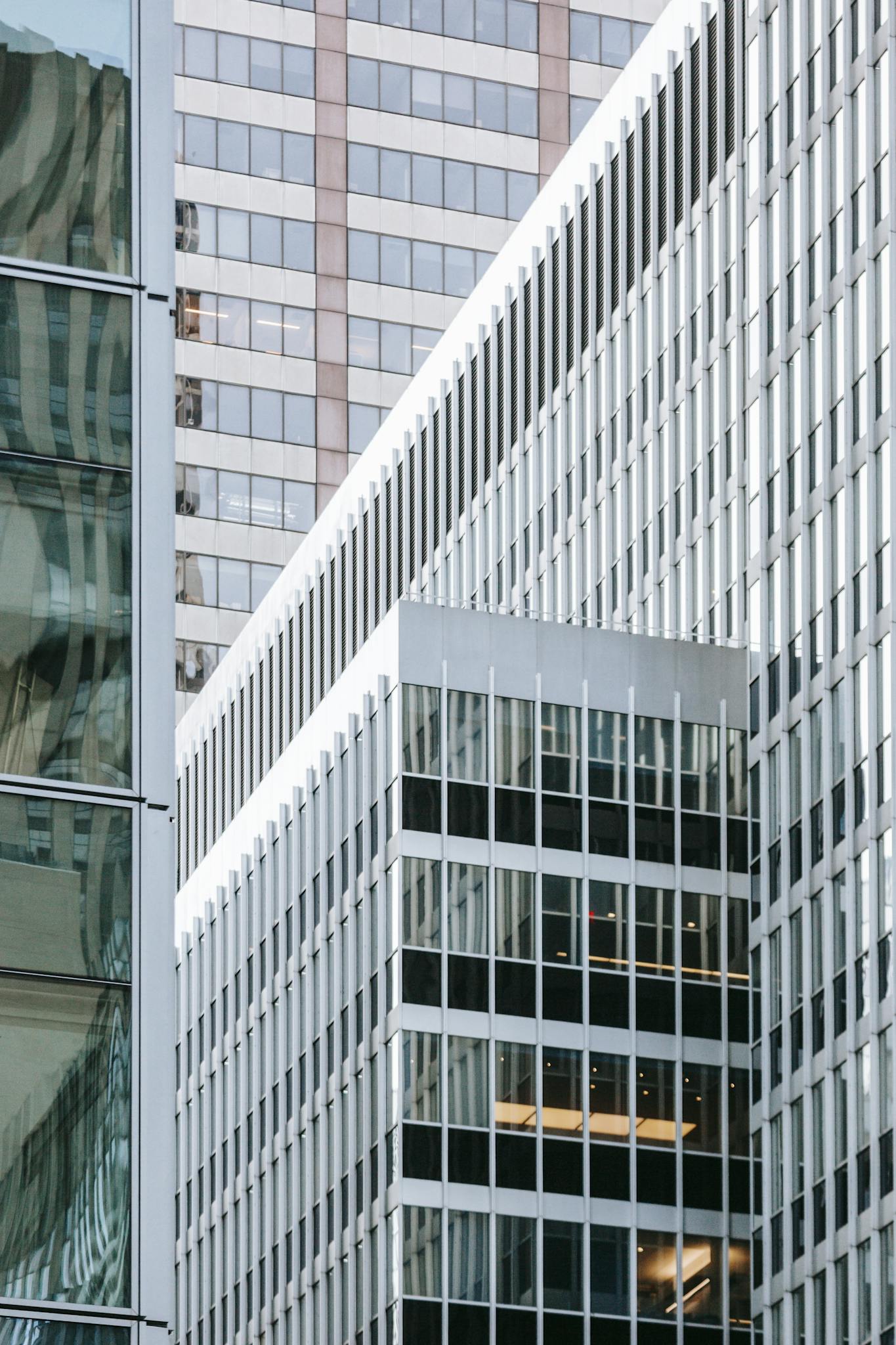 Modern skyscrapers in the city featuring reflective glass facades and urban design.